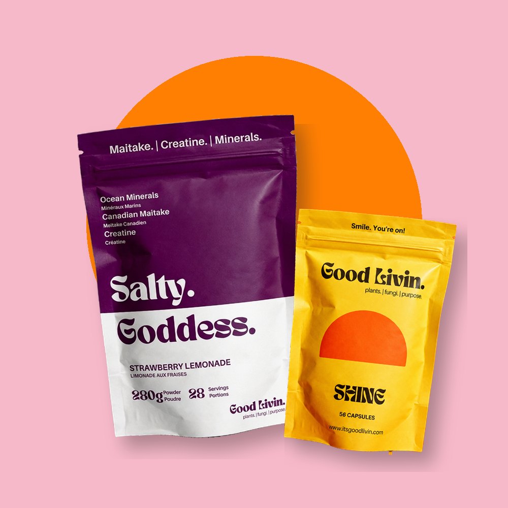 A bag of Salty Goddess and a bag of Shine on a yellow background with a pink sun